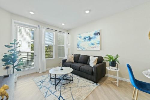 a living room with a couch and a table at Designer Apt with Jacuzzi, Sky Lounge, Gym Access in Sparks