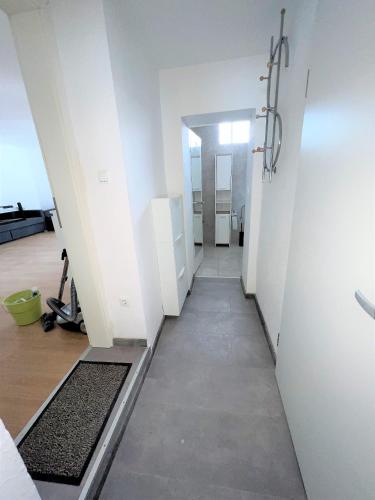 a hallway leading to a room with white walls at Wohnung in Düren Stadtmitte in Düren - Eifel