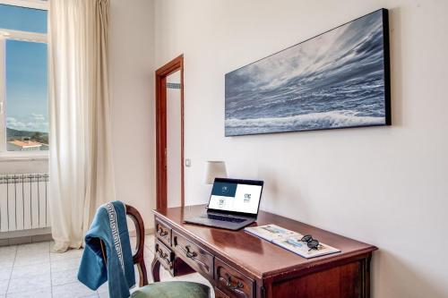 a desk with a laptop computer on top of it at Villa MG Hotel in Santa Marinella