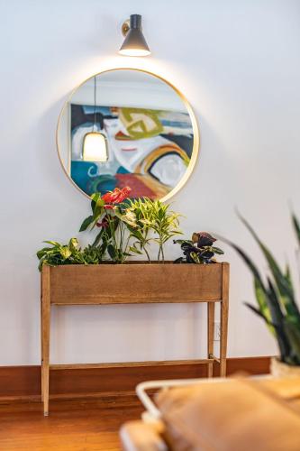 a mirror on top of a wooden table with a plant at Mackenzie House by Revelstoke Vacations in Revelstoke