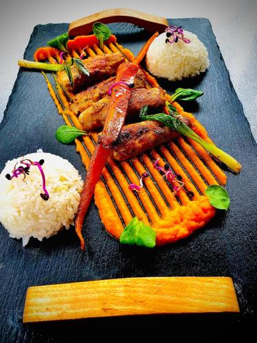 a plate of food with carrots and rice on a table at Fakanalas Fogadó in Pásztó