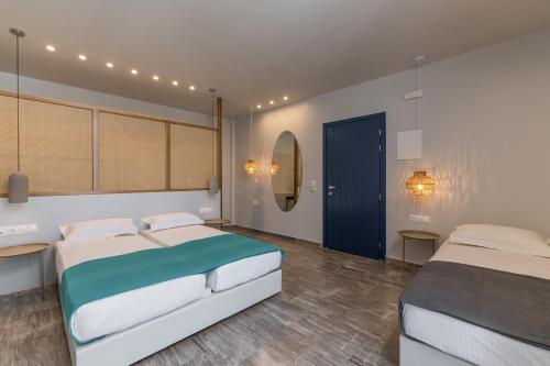 イオス島 チョーラにあるIos Fantasyのベッドルーム1室(ベッド2台、青いドア付)