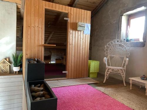 a room with a bench and a chair and a window at Le Château de Failloux, Piscine intérieure in Épinal