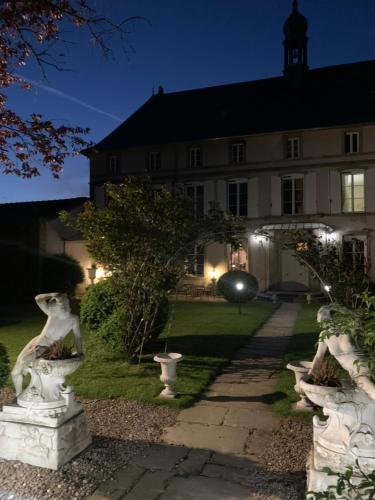 a building with statues in front of it at night at Le Château de Failloux, Piscine intérieure in Épinal