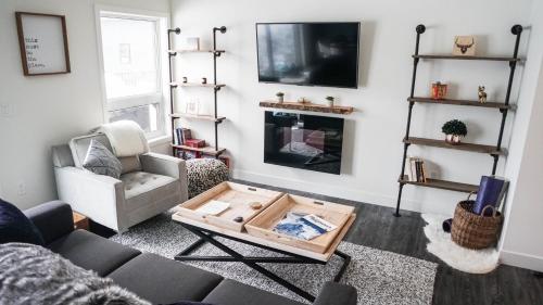 a living room with a couch and a coffee table at The Revy Den by Revelstoke Vacations in Revelstoke