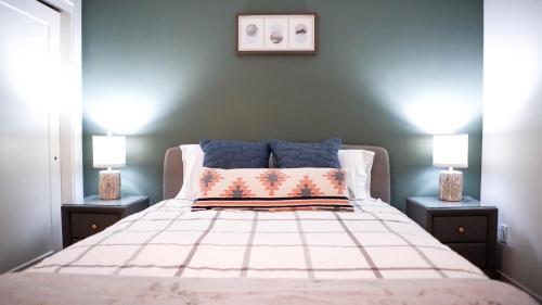 a bedroom with a large bed with two lamps at The Revy Den by Revelstoke Vacations in Revelstoke