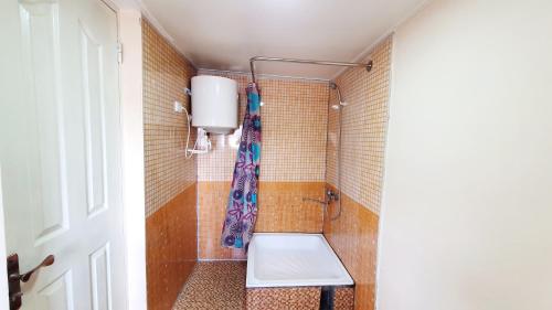 a bathroom with a shower with a toilet in it at Soliha&Yulduz Guesthouse in Bukhara