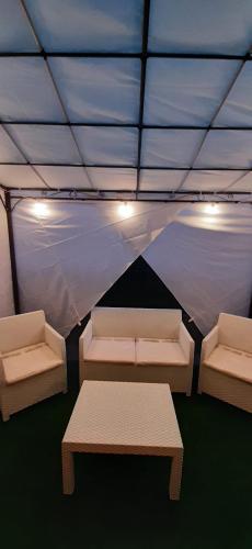 a tent with two benches and a table in it at Appartamento Lucia in Villanova dʼAsti