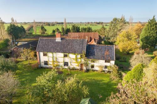 an aerial view of a house in a field at Valley Farmhouse, Westhall in Southwold