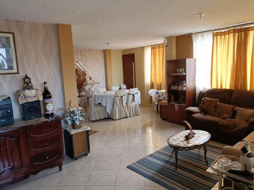 a living room with a couch and a table at Casa de campo Pillaro - Activa in Píllaro