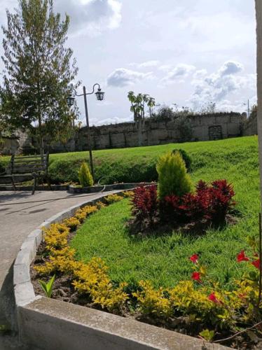 a garden with colorful flowers in a park at Casa de campo Pillaro - Activa in Píllaro