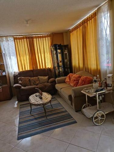a living room with a couch and a table at Casa de campo Pillaro - Activa in Píllaro