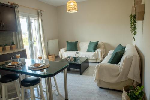 a living room with a couch and a table at Maresia Apts & Studios in Arillas