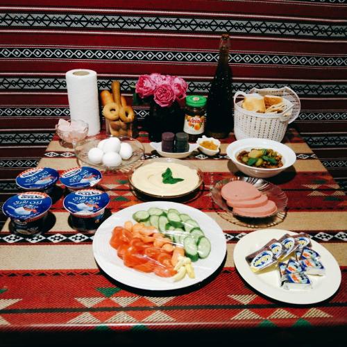 a table with plates of food on it at Majido Hotel in Wadi Musa