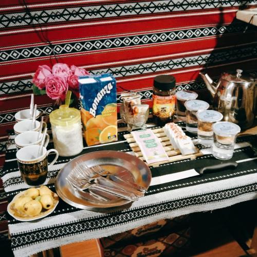 a table with food and other items on it at Majido Hotel in Wadi Musa