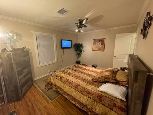 a bedroom with a bed and a ceiling fan at Charming 2 bedroom Retreat minutes from Downtown in Tulsa
