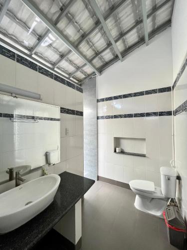 a bathroom with a sink and a toilet at Catsen Bungalows & Pool Phan Thiet in Phan Thiet