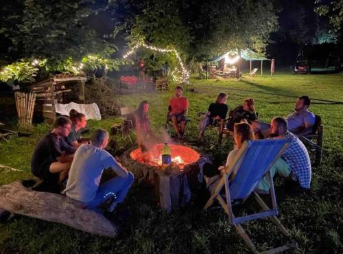 a group of people sitting around a campfire at night at Dumbo Eco Camp in Ozurgetʼi