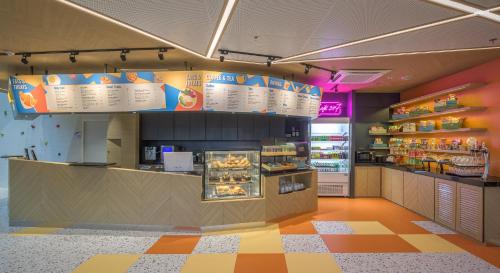 a fast food restaurant with a counter with food at COSI Krabi Ao Nang Beach - SHA Plus in Ao Nang Beach