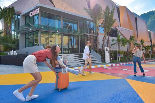 a group of people with luggage in front of a building at COSI Krabi Ao Nang Beach - SHA Plus in Ao Nang Beach