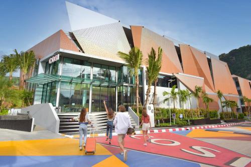 a group of people riding skateboards in front of a building at COSI Krabi Ao Nang Beach - SHA Plus in Ao Nang Beach