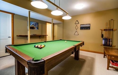 a pool table in a room with afits at Stoke Cabin by Revelstoke Vacations in Revelstoke
