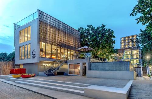 a building with a staircase in front of it at Centara Q Resort Rayong in Mae Pim