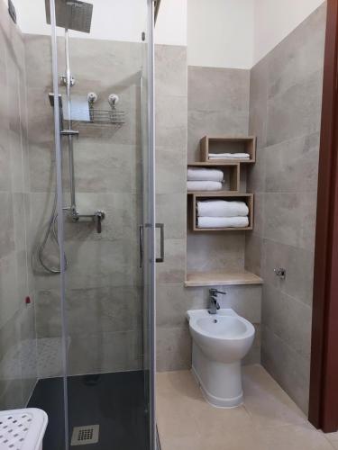 een badkamer met een douche, een toilet en een wastafel bij B&B Villa Martina in Sardara