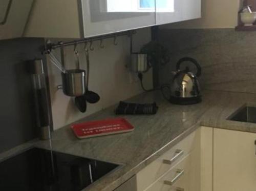 a kitchen with a counter top with a tea kettle at Ferienwohnung City Loft in Kiel