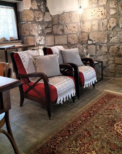 a living room with two chairs and a couch at Il Riuscello in Tuscania