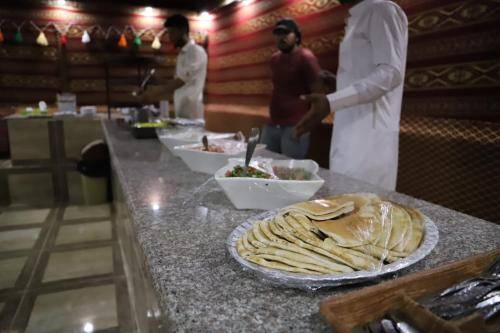a group of chefs in a kitchen preparing food at Bedouin desert camp in Wadi Rum