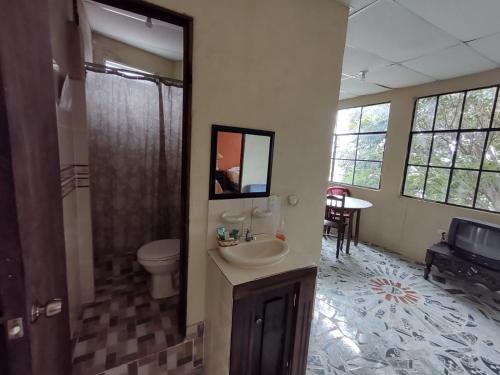 a bathroom with a sink and a toilet at Casa Elefante Dormido in Panajachel