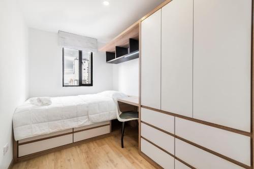 a bedroom with a bed and a desk at CentralX 18 in Bogotá