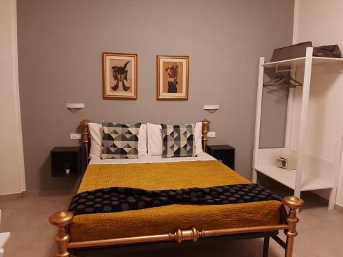 a bedroom with a bed with a yellow blanket and pillows at JustKey in La Spezia