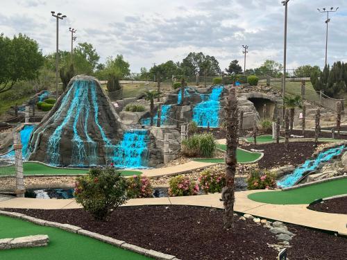 a water park with a water slide in the middle at Ledgerock lake house! Boat included march-October,outside bar, Pool table,family fun center in Hot Springs