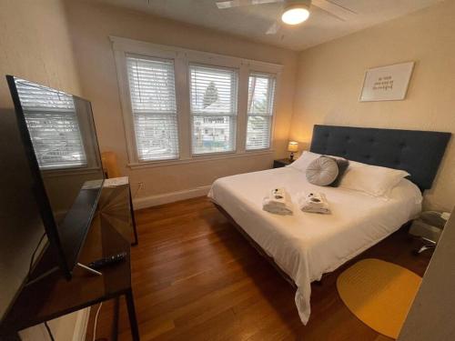 a bedroom with a bed with two towels on it at Cozy Large House close to TUFTS/Harvard/MIT 4BR in Medford
