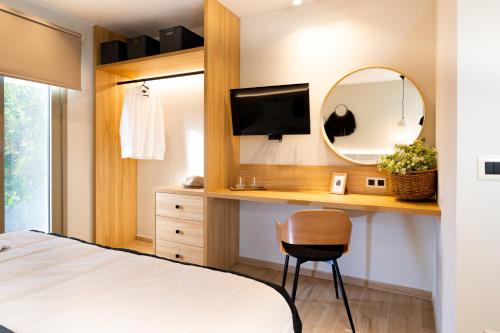 a bedroom with a bed and a mirror and a desk at Searenity Villa Malia with private swimming pool in Malia