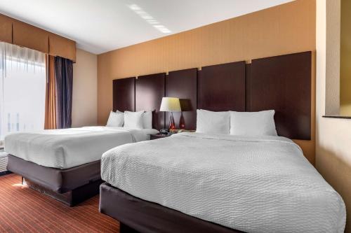 a hotel room with two beds and a window at Best Western Plus DFW Airport West Euless in Euless