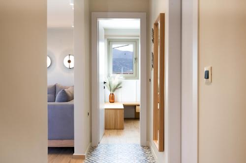 a hallway with a blue couch and a window at Searenity Villa Malia with private swimming pool in Malia
