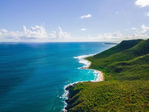 an aerial view of the ocean and a beach at St Martin Beach Resort & Spa in Anse Marcel 