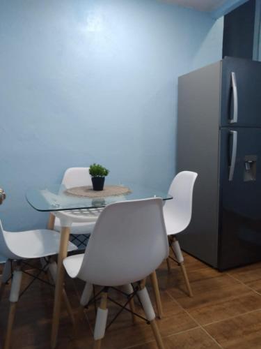 a table and chairs in a kitchen with a refrigerator at Paulino in Santiago de los Caballeros