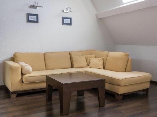 a living room with a couch and a coffee table at Gîte pour 12 face au château de Thillombois avec jardin, cheminée et équipements PMR - FR-1-585-38 in Thillombois