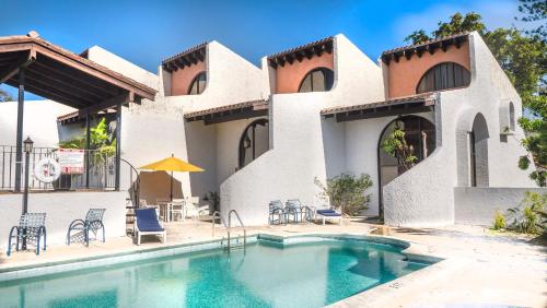 a house with a swimming pool in front of it at Villas at St James Place UNIT F, Luxury, Pet Friendly in Miami