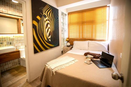 a bedroom with a bed with a laptop on it at Casa Azul in Lima