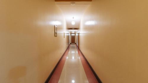 an empty hallway in a building with a long escalator at RedDoorz Premium @ Nick Hotel Gerona Tarlac in Tarlac