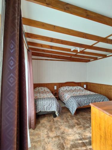 a bedroom with two beds in a room at "LaEmboscadapuntocl"Casas y departamentos en el huerto in Santa Cruz