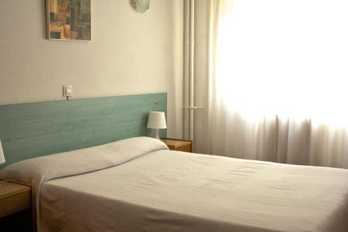 a bedroom with a bed and a window at Siracusa in Andorra la Vella