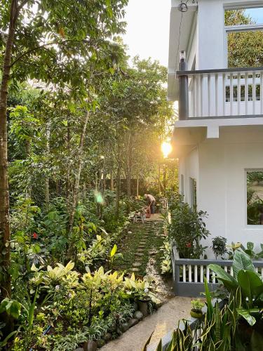 a garden outside of a house with a balcony at Casa Calanog in Tagaytay