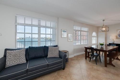 a living room with a couch and a dining room table at NEW Beach Condo 5 min walk to the Beach Sleeps 9 in Clearwater Beach