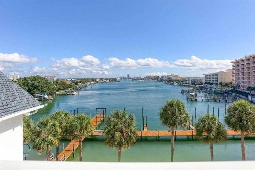 a view of a river with palm trees and buildings at NEW Beach Condo 5 min walk to the Beach Sleeps 9 in Clearwater Beach